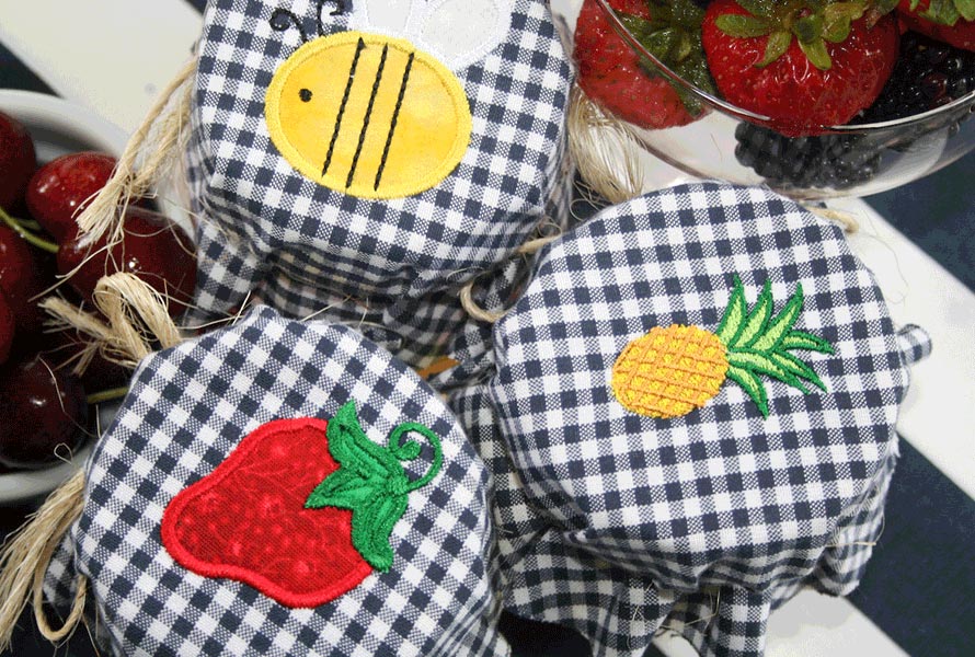 Canning jars wrapped with embroidered checkered pattern