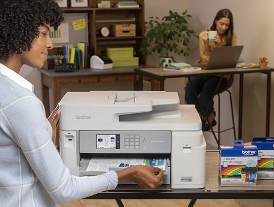 Woman taking document from Brother Inkjet printer