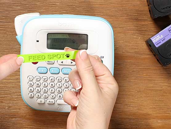 Green label tape in front of Ptouch Btag label maker.