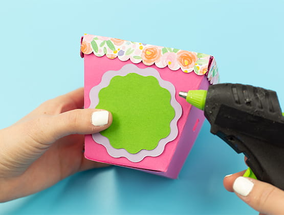 P-touch Embellish Easter Basket project step 7 hot gluing wavy circle on basket