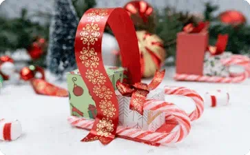 Holiday candy cane sleigh and ribbon