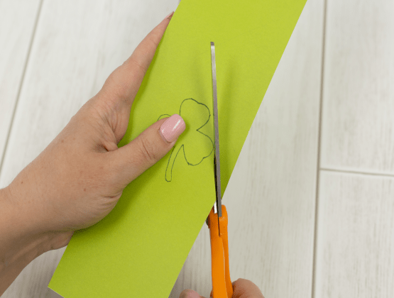 Step 1: Person cutting a shamrock for P-touch Embellish project.