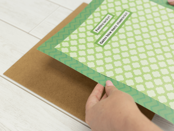 Step 5:  Person affixing the patterned paper to the shadowbox for P-touch Embellish project.