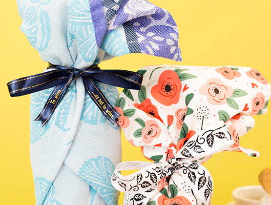 Completed wrapped wine bottle with P-touch Embellish ribbon to tie shut.