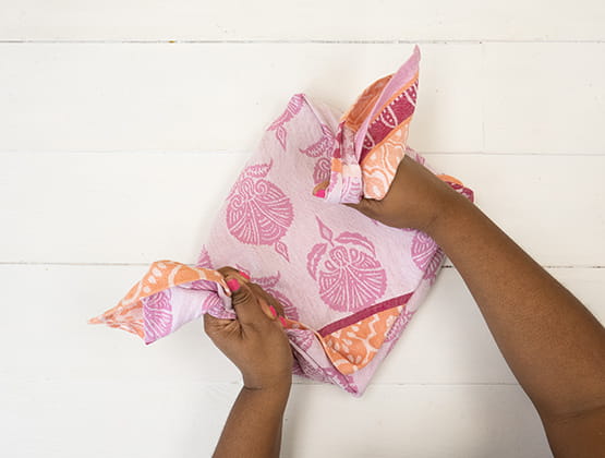 P-touch embellish craft step 3: Person tying tea towel. 