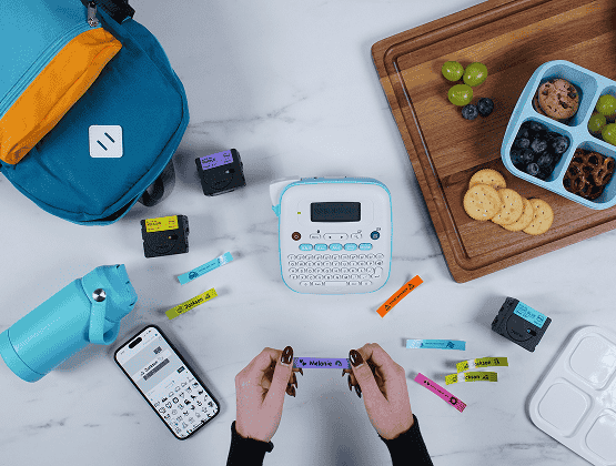 Brother Ptouch Label Maker with water bottles, label tapes, backpacks and food containers - Person Holding a Printed Ptouch Label