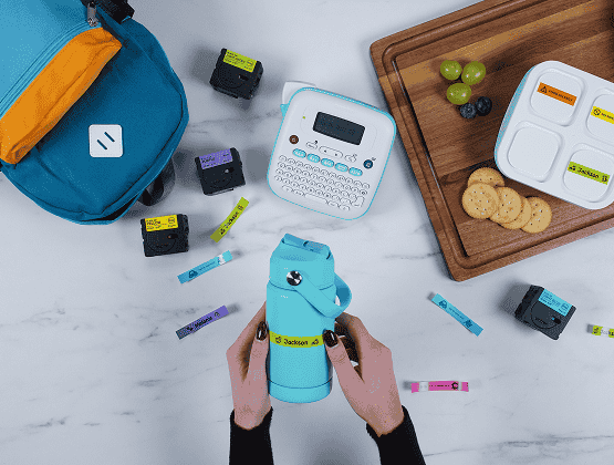 Brother Ptouch Label Maker with water bottles, label tapes, backpacks and food containers - Person holding a Bottle while sticking the Label on it