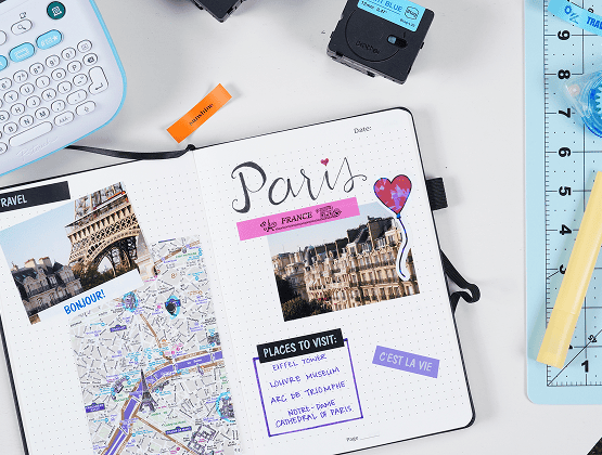 A completed Paris travel journal spread with labeled images, map cutouts, and decorative stickers.