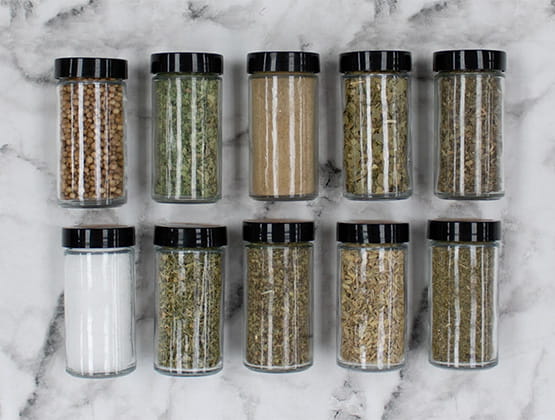 A variety of spices laying on marble countertop