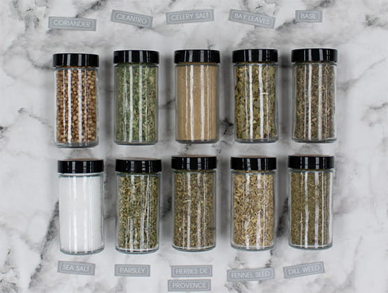 A variety of spices laying on marble countertop