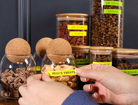 Yellow label with Beau's Treats being adding to a jar