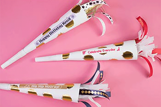 Labeled party horns with gold dots on pink background