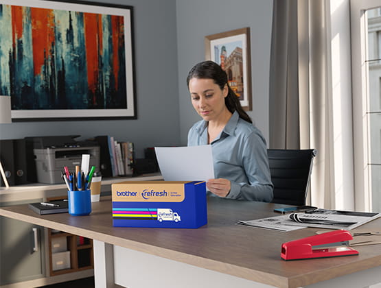 Woman with Paper with Refresh Ink Box in front of her