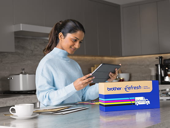 Woman Holding a tablet with Brother Refresh Box in front of her