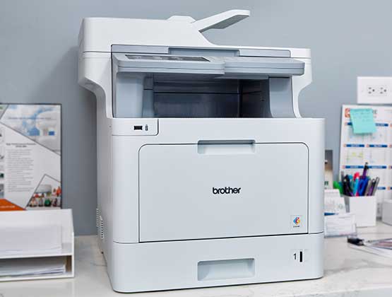 Brother Color laser printer with print-as-a-service capability sitting on office desk