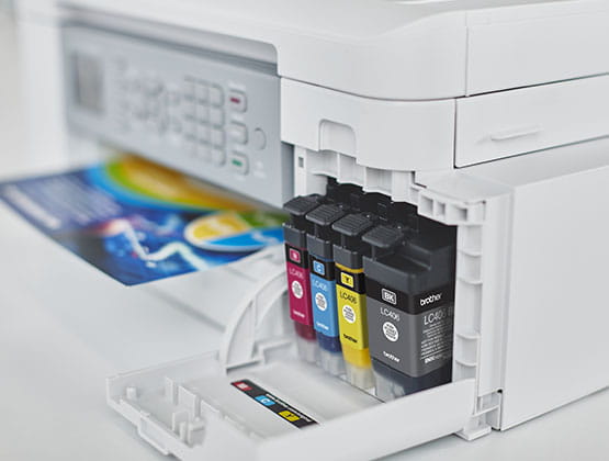 Printer with open ink tank showing color cartridges
