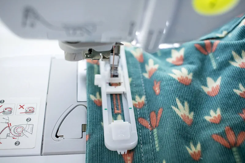 Put fabric under machine