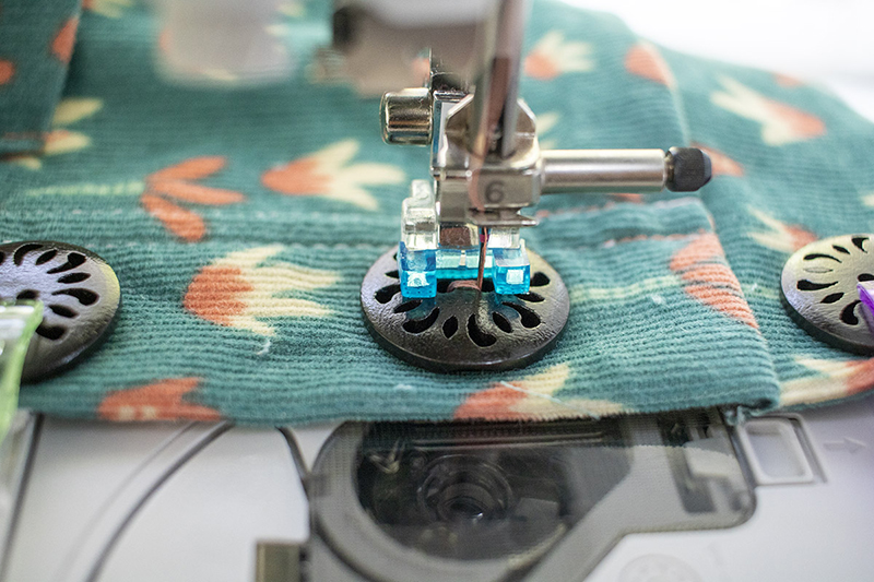 stitch button in place