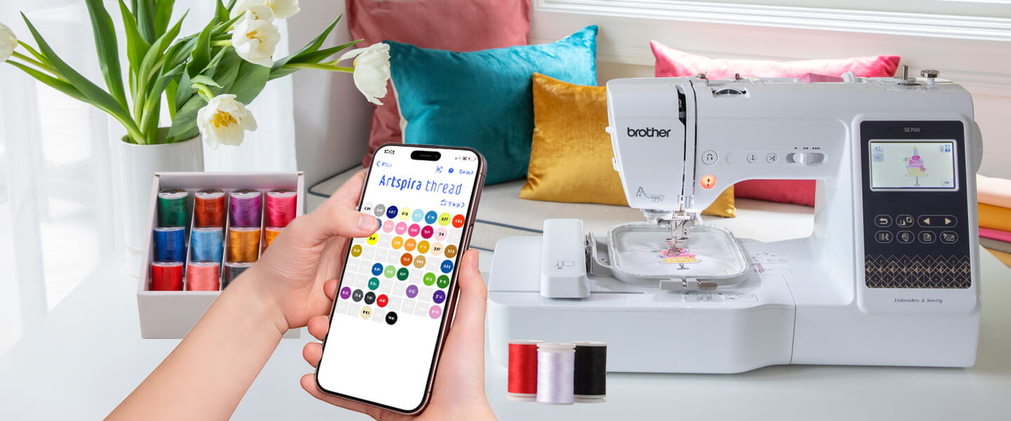 Artspira, Import your own designs and transfer wirelessly, photo showing phone connecting to sewing machine