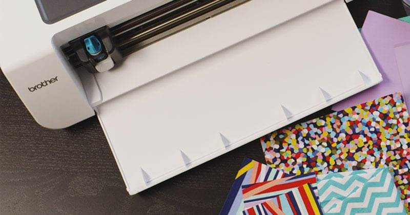 Brother DesignNCut machine with a variety of craft papers of different weights and patterns