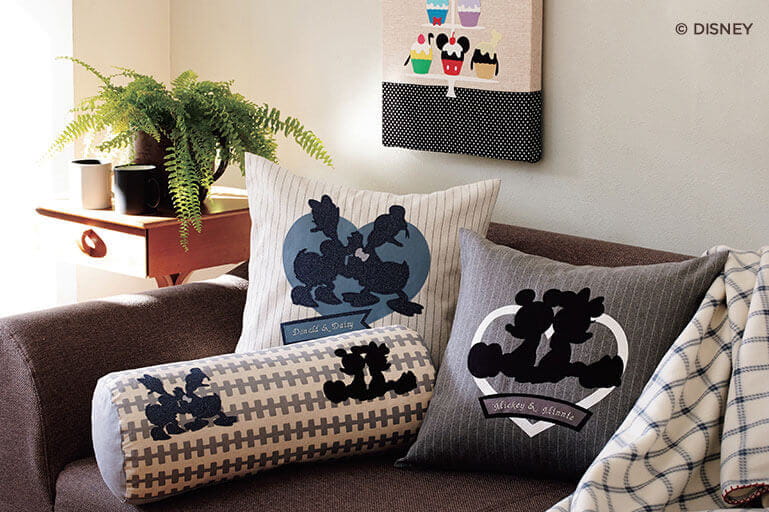 Pillows with Disney cut patterns on couch