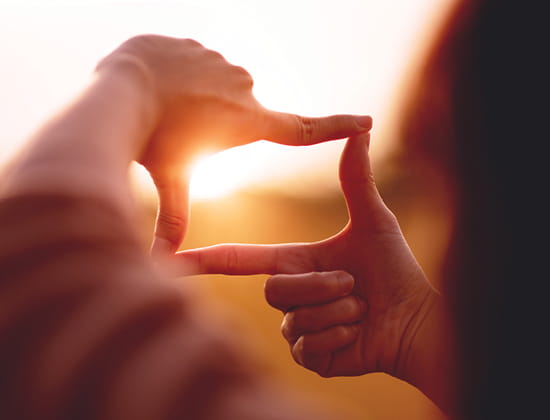 Hands framing sunset