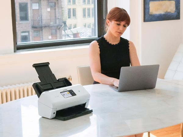 Woman working in a conference room with scanner on the table
