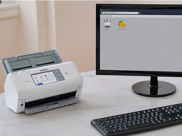 Scanner on office desk with PC computer showing scan software