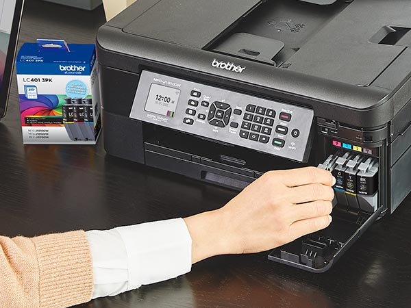 Person installing LC401XL ink cartridges in printer