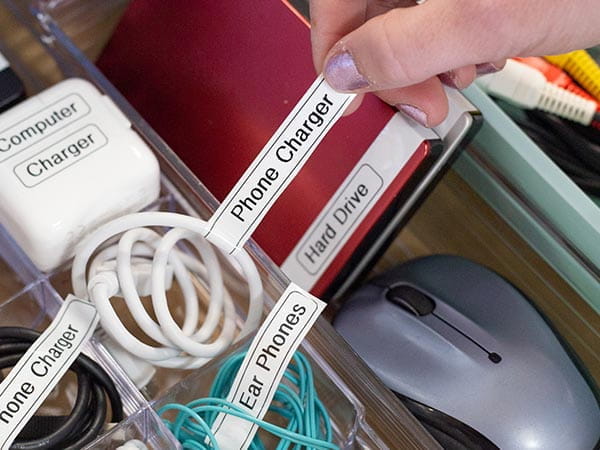Organized drawer with labelled cords, cables, and flash drives