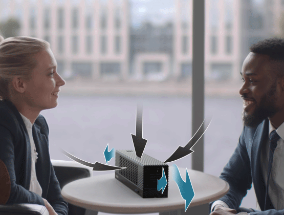 Male and female coworker sitting across from each other at table with Airsure Air Purifier on table