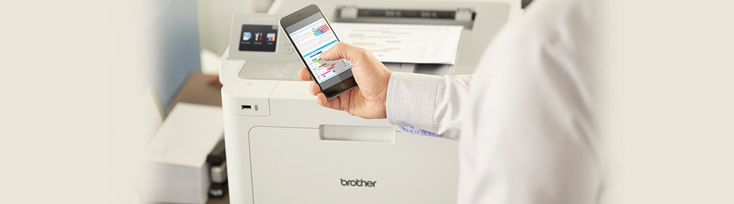 Person using a cell phone to connect to Brother HL-L9310CDW printer 