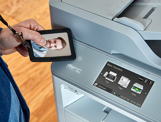 Person scanning badge to use MFCL6900DW printer