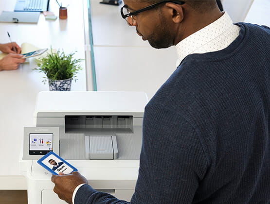 Man scanning badge at a Brother HL-L9470 printer