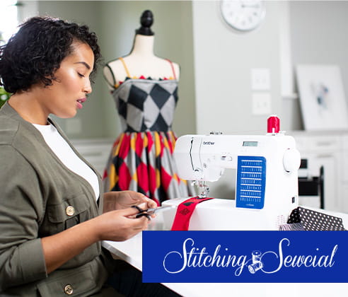 Woman sewing on Brother sewing machine with a dress in background