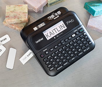PTD610BT on desk printing label with text "Kaitlin"