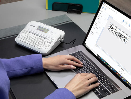 Person using laptop to create label for printing on PT-D410 label maker
