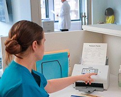 Medical associate using ADS-4700W at desk