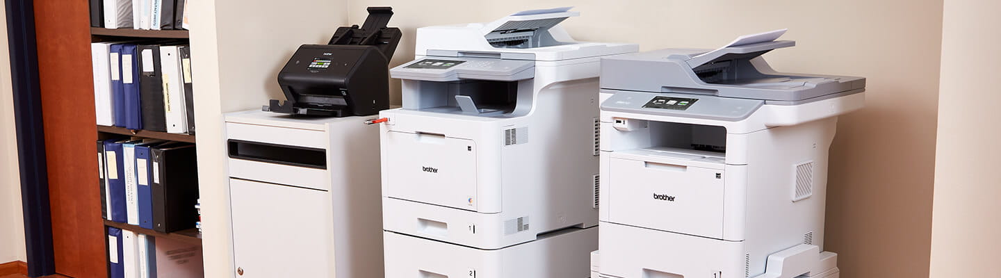 ADS-3600, MFC-L9570CDW and MFC-L6900DW printers in an alcove.