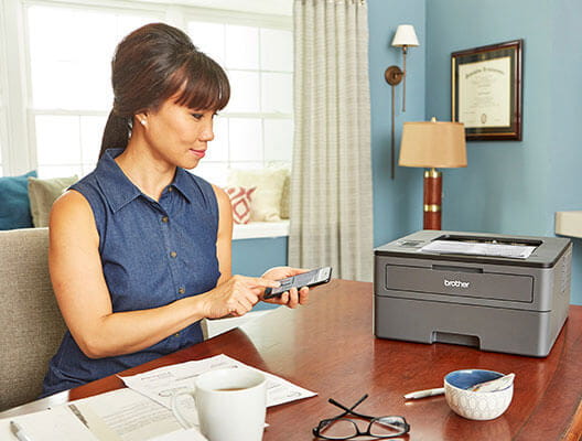 Woman mobile printing in home office