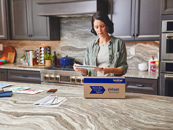 Woman with mail and refresh box on counter
