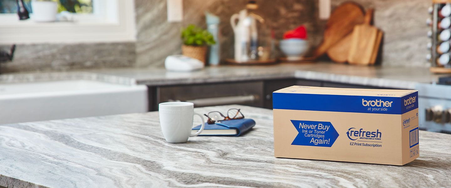 Refresh box on countertop with notebook, glasses and coffee mug