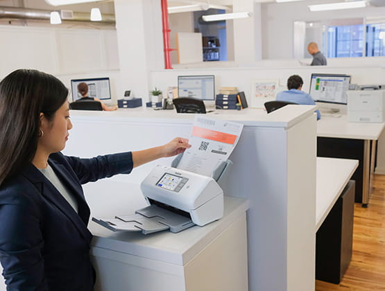 Woman using Brother scanner in a office setting
