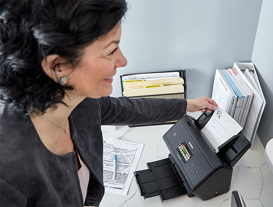 Woman printing paper prescription.