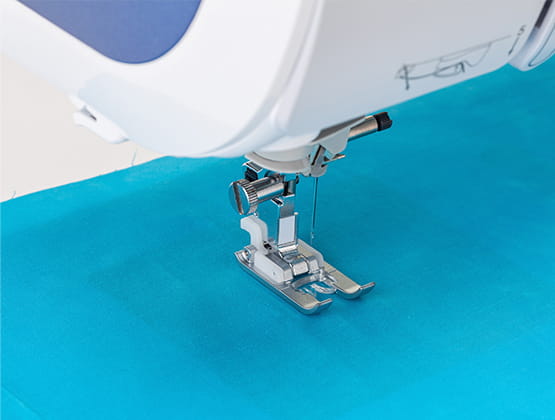 N monogramming foot on XP3 over a piece of blue fabric.