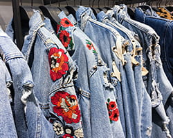Denim jackets with red floral embroidery on sleeves