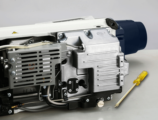 Industrial sewing machine motor on table with screwdriver