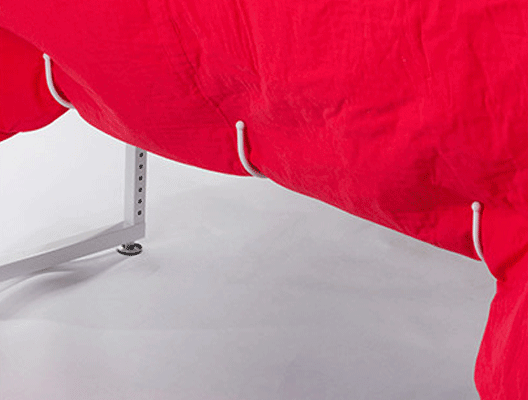 Five big hooks underneath THE Dream Fabric Frame keep excess fabric off the floor and out of your way