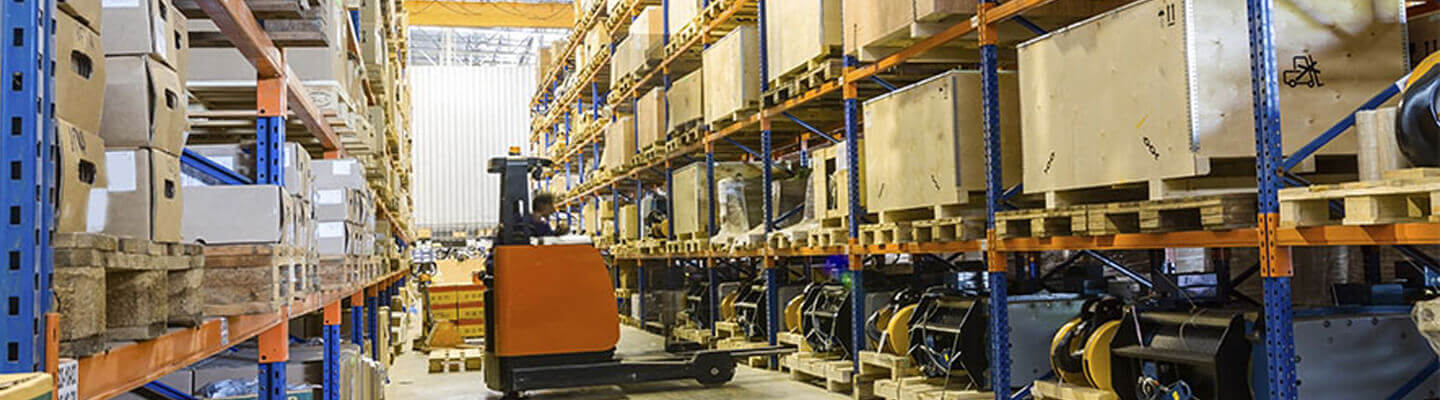 Forklift operator in warehouse aisle