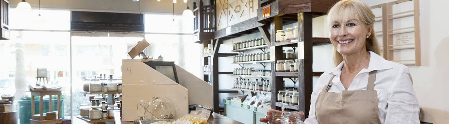 Smiling woman behind retail store counter